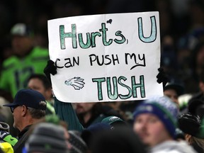 An NFL fan holding a sign about the Eagles' Tush Push