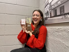 Molly Schikosky celebrates after a win at the 2023 Saskatchewan Music Awards. To make sure she acknowledged all her collaborators on stage, she wrote their names in borrowed lipstick on a playing card.
