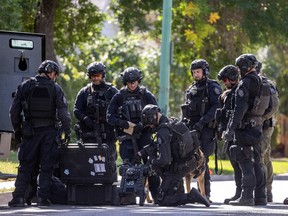 REGINA, SASK : September 9, 2022 -- Members of the Regina Police Service SWAT team take at least three people into custody during a call on the 1400 block of Queen Street on Friday, September 9, 2022 in Regina.
