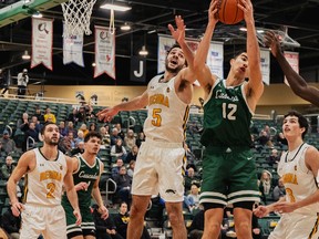 Twin brothers Matt (2) and Nick Barnard (5) play defence for the University of Regina in a Canada West basketball game against the University of Fraser Valley on Nov. 24, 2023 in Regina.