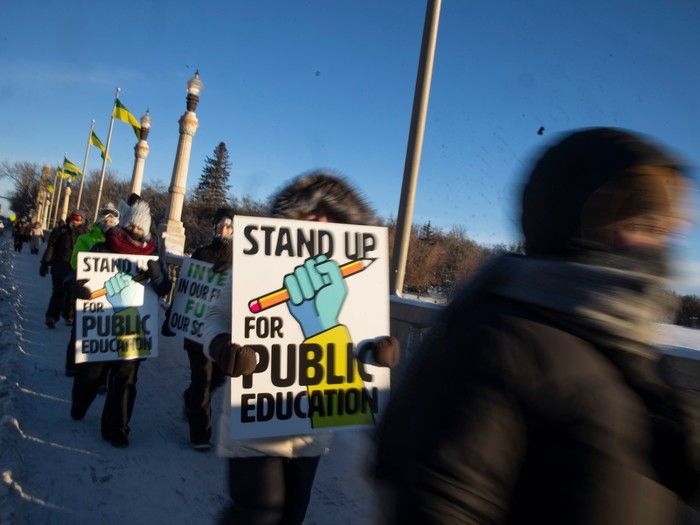 Saskatchewan Teachers' Federation members and supporters march across the Albert Memorial Bridge during a provincial teachers strike on Tuesday, January 16, 2024 in Regina.