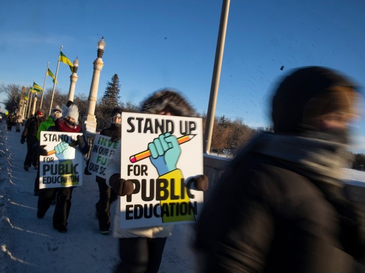  Saskatchewan Teachers’ Federation members and supporters march across the Albert Memorial Bridge during a provincial teachers strike on Tuesday, January 16, 2024 in Regina.