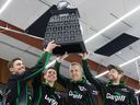 Team McEwen hoists up their trophy after defeating Team Kleiter in the 2024 SaskTel Tankard final at Nutana Curling Club.
