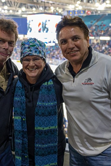Dave Repsher, from left, his wife Amanda Repsher and Marty Richardson with Dawg Nation attend a Saskatoon Blades hockey game at SaskTel Centre in Saskatoon, Feb. 23, 2024. (Michelle Berg / Saskatoon StarPhoenix)