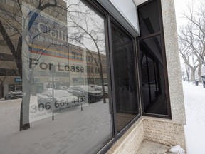 A For Lease sign is displayed in the window of a vacant office building downtown Saskatoon in December of 2022.