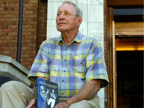 Gerry James poses with his book outside the Sask Sport Hall of Fame and Museum before a promotional event in 2011.