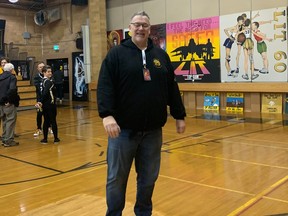 Former Luther Lions centre Bill Knudsen on "the spot" inside his high school's old gymnasium, from where he hit a memorable basketball shot to force overtime and ultimately win the 1984 LIT championship. Cellphone photo by Darrell Davis.