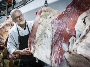 Butcher John Wildenborg works in his independent meat shop in Calgary, Wednesday, Feb. 14, 2024.