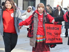 Elder Geraldine Shingoose was one of hundreds who took part in a round dance during a search the landfill rally and round dance held in downtown Winnipeg at the corner of Portage and Main on Friday morning.