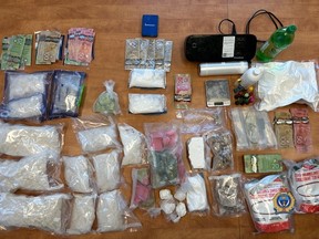 This submitted photo shows drugs, cash and other items seized during a Mar. 1, 2024 drug bust by the Regina Police Service.