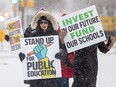 Teachers holds signs during a full-day teacher's strike in Saskatoon, Sask. in February of 2024.