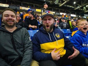 Fans react to a play during the third period of the first game of WHL Eastern Conference final of Saskatoon Blades against Moose Jaw Warriors at SaskTel Centre in Saskatoon, Sask., on Friday, April 26, 2024.