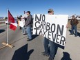 Demonstrators line the Trans-Canada Highway west of Calgary protesting the carbon tax on Monday, April 1, 2024.