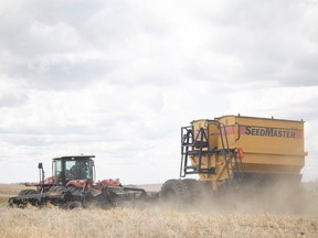A farmer drives a tractor across a field to seed peas during the beginning of the farming season in May of 2022 near Serath. KAYLE NEIS / Regina Leader-Post