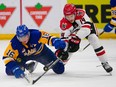 Saskatoon Blades forward Fraser Minten (16) and Moose Jaw Warriors forward Ethan Semeniuk (14) battle for the puck during the first period of the first game of WHL Eastern Conference final at SaskTel Centre in Saskatoon on Friday, April 26, 2024.