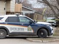 Police cruisers and tape surround a home on 33rd Street West in Saskatoon, while the major crime section investigate the death of a woman. Photo taken in Saskatoon, Sask. on Tuesday, April 16, 2024.