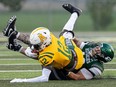 Nick Wiebe, shown tackling Alberta's Chevy Thomas, has been drafted by the Saskatchewan Roughriders.