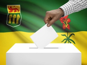 A ballot box is seen in front of a Saskatchewan flag in this photo illustration.