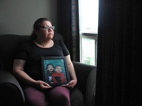REGINA, SASK : May 30, 2024 -- Richelle Dubois holds a photo of her sons Haven (left in frame) and James while sitting in the Royal Hotel in Regina, Saskatchewan on May 30, 2024. Richelle found Haven unresponsive in an east Regina Creek in May 2015. An inquest into his death was held at the hotel in late May 2024. BRANDON HARDER / Regina Leader-Post
