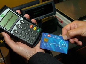 A sales transaction using a point-of-sale terminal is demonstrated in Toronto in this 2007 photo.