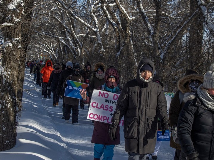  Striking teachers and their supporters march down Albert Street by the Saskatchewan Legislative Building on March 4, 2024 in Regina. This action coincided with the first day of the spring legislative session.