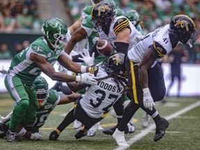 Hamilton Tiger-Cats receiver Lawrence Woods III (37) fumbles the ball during the first half of CFL action at Mosaic Stadium on Sunday, June 23, 2024 in Regina.