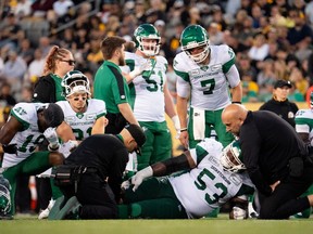 Saskatchewan Roughriders offensive lineman Philip Blake (53) lies injured during second half CFL football action against the Hamilton Tiger Cats in Hamilton, Ont., Sunday, June 16, 2024.