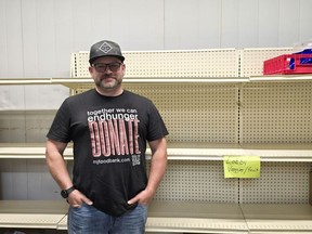 Jason Moose stands in front of empty shelf.