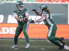 Saskatchewan Roughriders quarterback Jake Maier (9) hands the ball to Saskatchewan Roughriders running back A.J. Ouellette (45) during the first half of CFL action at Mosaic Stadium on Saturday, June 28, 2025 in Regina.