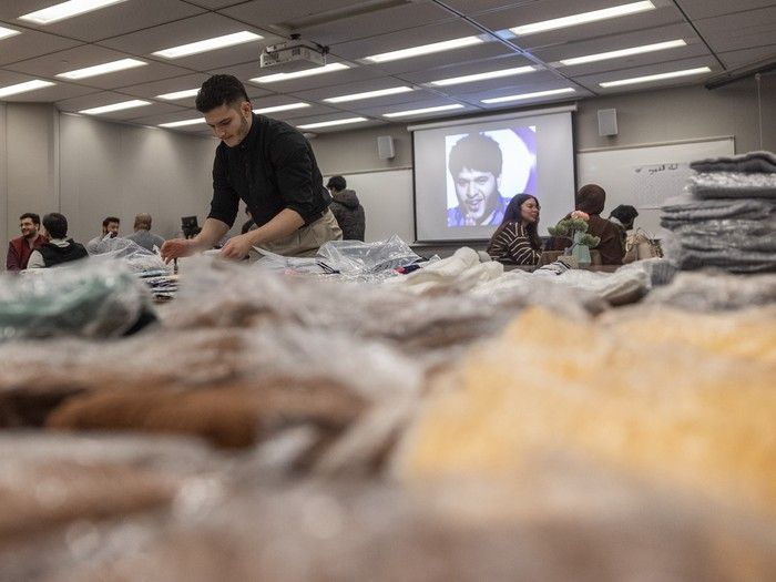 Dozens of volunteers on foot handed out winter packages to homeless people outside of Carmichael Outreach Regina on Saturday.