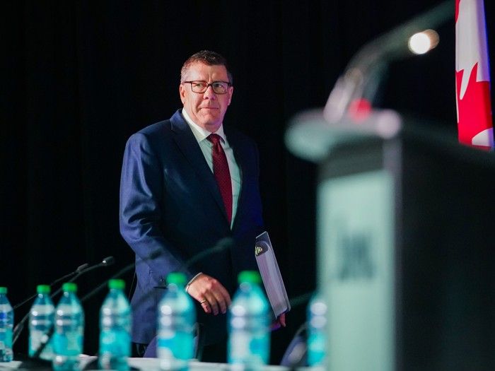 Scott Moe walks off the stage after speaking with his cabinet