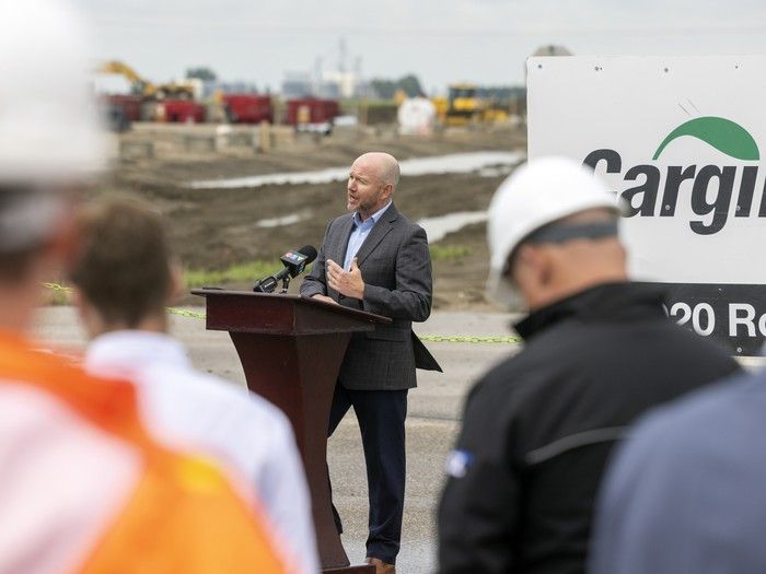 Jeff Vassart speaks at a podium at the ground breaking ceremony outside