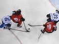 TOPSHOT - (L-R) Finland's Jarno Koskiranta, Canada's Linden Vey, Canada's Andrew Ebbett and Finland's Miika Koivisto fight for the puck in the men's quarter-final ice hockey match between Finland and Canada during the Pyeongchang 2018 Winter Olympic Games at the Gangneung Hockey Centre in Gangneung on February 21, 2018.   / AFP PHOTO / Kirill KUDRYAVTSEVKIRILL KUDRYAVTSEV/AFP/Getty Images