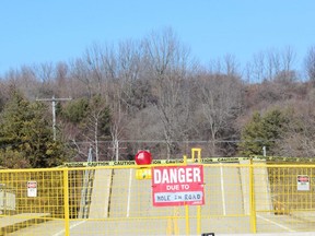 A sign warns motorists at the collapsed Imperial Road bridge in Port Bruce on Sunday. The structure gave out while a fully-loaded dump truck was driving across it Friday. (DALE CARRUTHERS, The London Free Press)