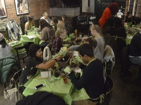 Plant Nite draws a crowd at a hip hop bar in downtown Boston where kindred spirits come to learn the craft of terrarium building. (Tracee Herbaugh via AP )