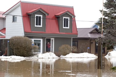 Bryn Duffett  and her brother Hamish stand in their doorway of their  Hale St. home in Port Bruce, Ont. on Tuesday February 20, 2018. Rain and melting snow has flooded much of the town.Derek Ruttan/The London Free Press/Postmedia Network