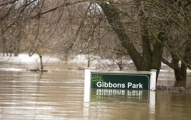 The Gibbons Park sign shows the depth of the flood waters in the park in London, Ont.  Photograph taken on Wednesday February 21, 2018.  Mike Hensen/The London Free Press/Postmedia Network