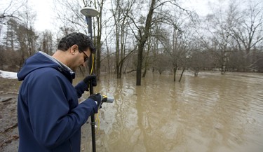 Mahmoud Pejam of the UTRCA uses a GPS device to measure the extent of flood waters on the north branch of the Thames River. Pejam a Water Resources Project co-ordinator says the measurements help to "calibrate our models," in London, Ont.  Photograph taken on Wednesday February 21, 2018.  Mike Hensen/The London Free Press/Postmedia Network