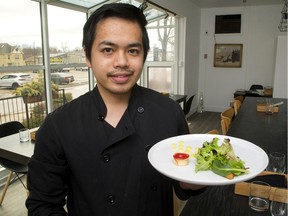 Reverie chef and owner Brian Sua-an displays a dish of Berkshire pork. Trained in his native Philippines, Sua-an and his wife Jerrah focus on quality and simplicity at their 12-seat restaurant. Serving a whole meal takes about two hours and the pair accompany each course with an explanation of the ingredients and how the dish was prepared. (Mike Hensen/The London Free Press)