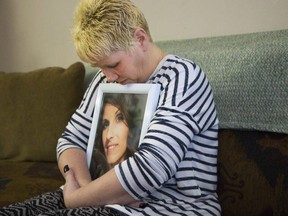 Tracey Vondette Wilcox embraces a photo of her daughter Christina Smith in London. Photo taken Feb. 26, 2018, shortly after Smith's death. (DEREK RUTTAN, The London Free Press)