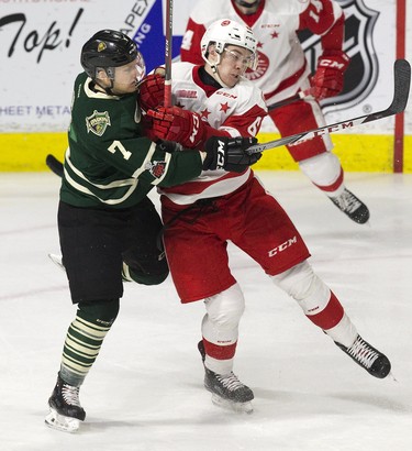 Shane Collins of the London Knights collides with Jordan Sambrook of the Sault Ste. Marie Greyhounds during the third period of their OHL hockey game in London, Ont. on Sunday February 25, 2018. Derek Ruttan/The London Free Press/Postmedia Network