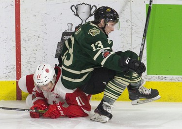 London Knight Tyler Rollo falls on top of the Sault Ste. Marie Greyhound Mac Hollowell during the third period of their OHL hockey game in London, Ont. on Sunday February 25, 2018. Derek Ruttan/The London Free Press/Postmedia Network