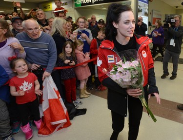 Tessa Virtue with flowers given to her by a fan after arriving at London International Airport on Monday February 26, 2018 back from the Olympic games where they won gold in the ice dance MORRIS LAMONT/THE LONDON FREE PRESS /POSTMEDIA NETWORK