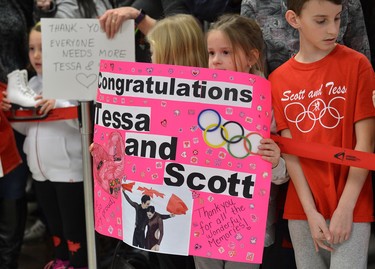 Mckennah McIndoo, 6, holds a pink sign while waiting with a large crowd to see Scott Moir and Tessa Virtue arriving at London International Airport on Monday February 26, 2018 back from the Olympic games where they won gold in the ice dance MORRIS LAMONT/THE LONDON FREE PRESS /POSTMEDIA NETWORK