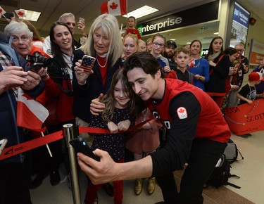 Scott Moir takes a selfie with Mackenzie Graves, 7, of Ilderton after arriving at London International Airport on Monday February 26, 2018 back from the Olympic games where they won gold in the ice dance MORRIS LAMONT/THE LONDON FREE PRESS /POSTMEDIA NETWORK