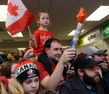 A fan on dad's shoulders waiting with a large crowd to see Scott Moir and Tessa Virtue arriving at London International Airport on Monday February 26, 2018 back from the Olympic games where they won gold in the ice dance MORRIS LAMONT/THE LONDON FREE PRESS /POSTMEDIA NETWORK