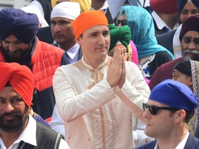 Canadian Prime Minister Justin Trudeau (C) pays his respects at the Sikh Shrine Golden temple in Amritsar on February 21, 2018. Trudeau and his family are on a week-long official trip to India. NARINDER NANU/AFP/Getty Images