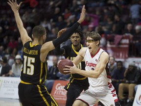 Windsor's Logan Stutz drives against London's Garrett Williamson in NBL Canada action between the London Lightning and the Windsor Express at the WFCU Centre, Sunday, March 25, 2018.  (DAX MELMER/Windsor Star)