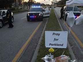 A sign calls for prayer near Marjory Stoneman Douglas High School a few days after a shooting killed 17 people at the school in Parkland, Fla. Joe Raedle/Getty Images