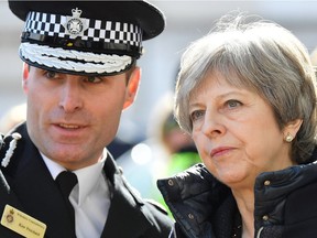 Britain's Prime Minister Theresa May (R) talks with Wiltshire Police's Chief Constable Kier Pritchard in Salisbury, southern England, on March 15, 2018, as she is shown the areas where former Russian double agent Sergei Skripal and his daughter Yulia went to, and were discovered at, on March 4, following an apparent nerve agent attack.